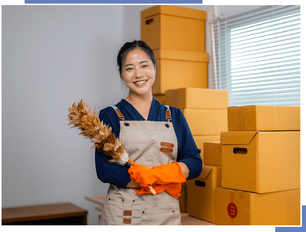 Smiling woman cleaning with feather duster.