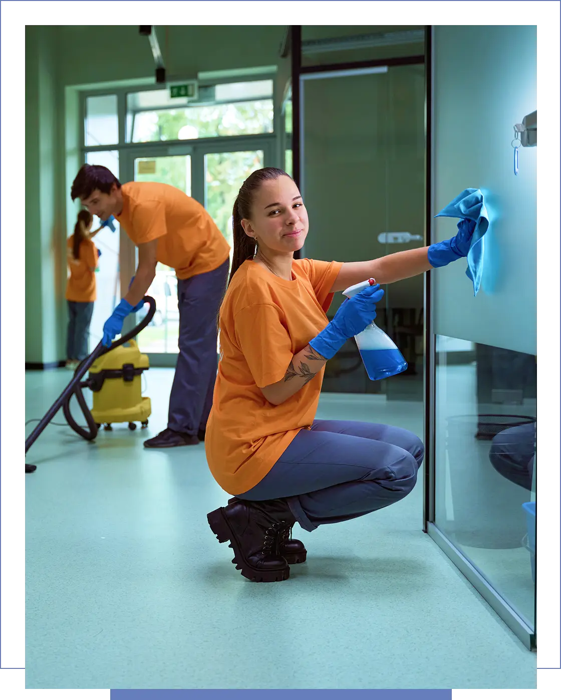 People cleaning with vacuum and spray bottles.